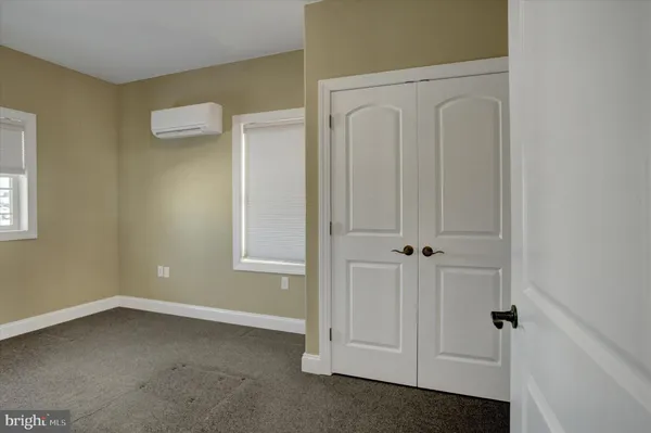 an empty room with closet area