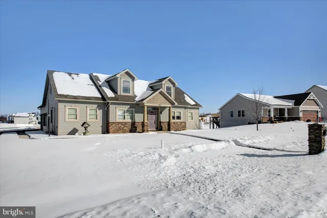 a front view of a house with a snow in front of it