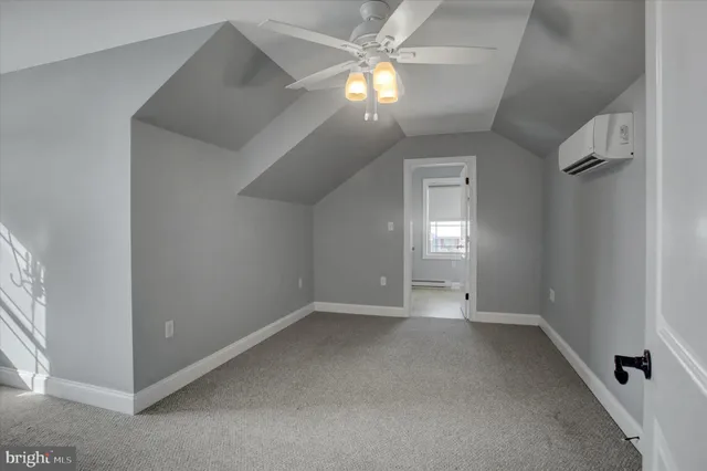 an empty room with a chandelier fan