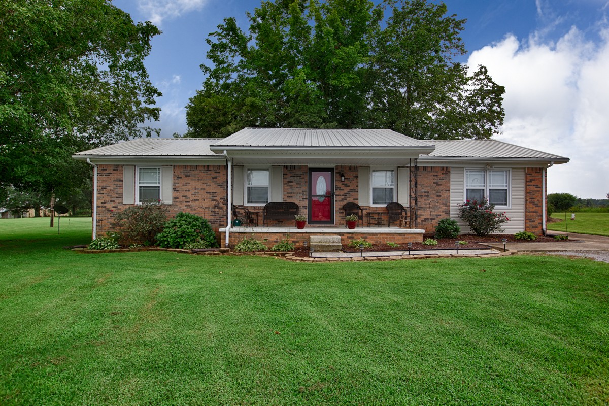 61 Slaughter Pen Road Ardmore, TN 38449 - Photo 1 of 23 a view of a house of a back side with garden and patio