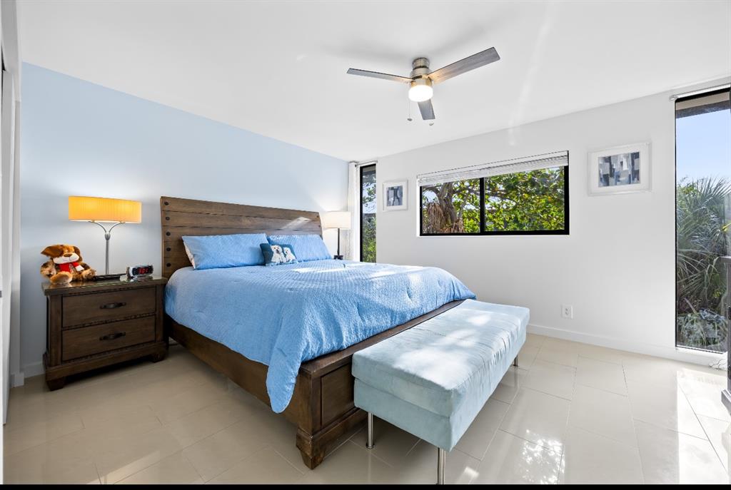 1901 North Andrews Avenue, Unit 222 Wilton Manors, FL 33311 - Photo 11 of 23 a bedroom with a bed and a chandelier