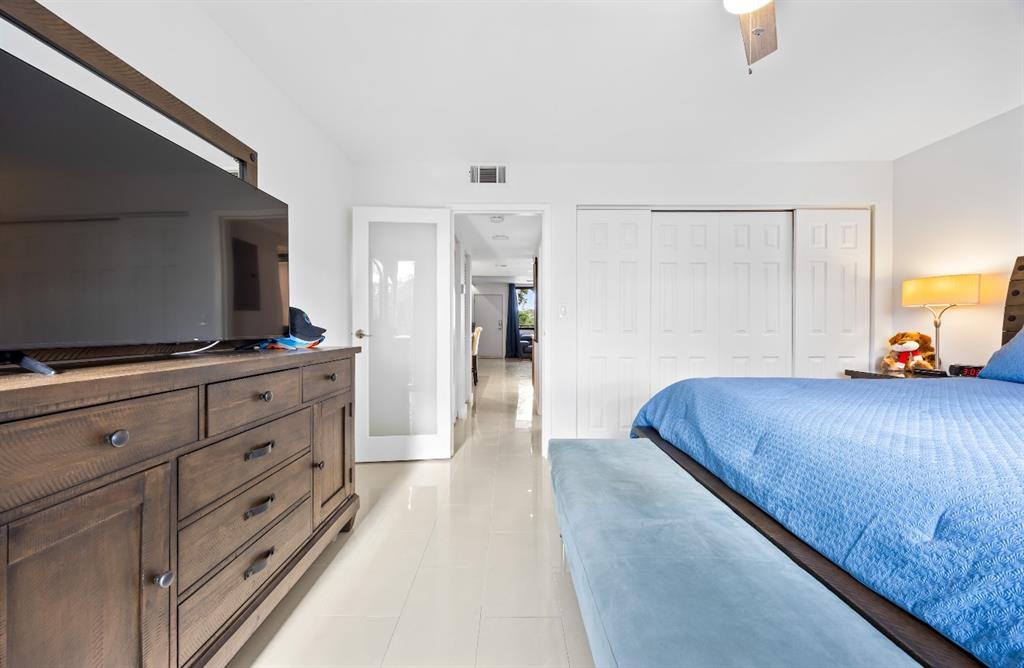 1901 North Andrews Avenue, Unit 222 Wilton Manors, FL 33311 - Photo 12 of 23 a bedroom with a bed and a flat screen tv