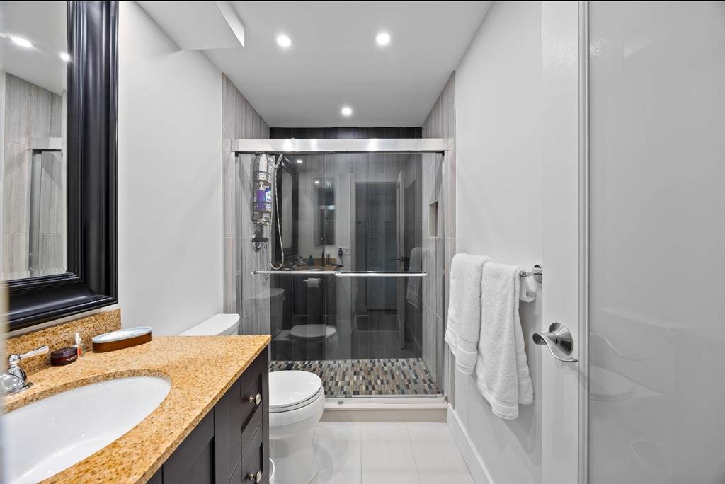 1901 North Andrews Avenue, Unit 222 Wilton Manors, FL 33311 - Photo 14 of 23 a bathroom with a granite countertop sink toilet and shower