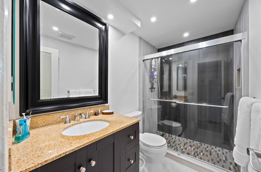 1901 North Andrews Avenue, Unit 222 Wilton Manors, FL 33311 - Photo 15 of 23 a bathroom with a granite countertop sink toilet and shower