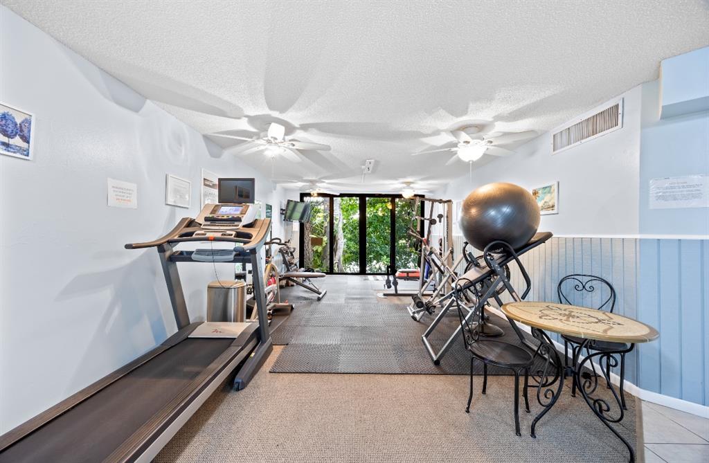 1901 North Andrews Avenue, Unit 222 Wilton Manors, FL 33311 - Photo 21 of 23 a view of a livingroom with furniture a ceiling fan and a chandelier