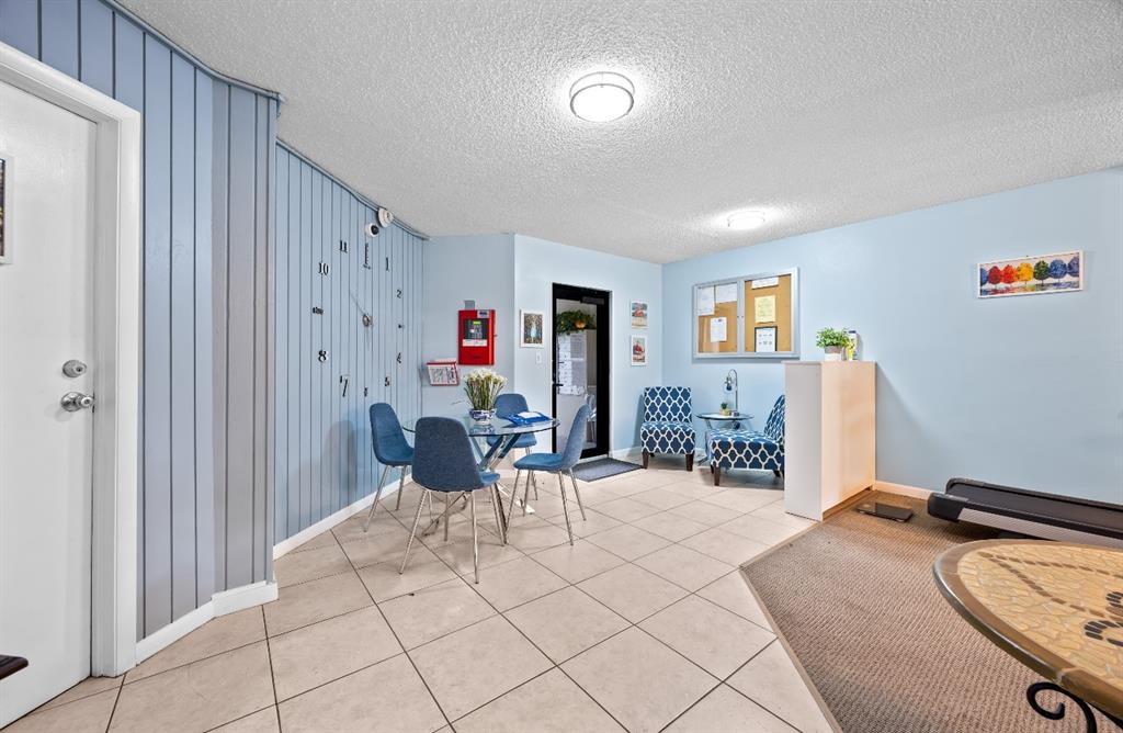 1901 North Andrews Avenue, Unit 222 Wilton Manors, FL 33311 - Photo 22 of 23 a living room with furniture and a flat screen tv