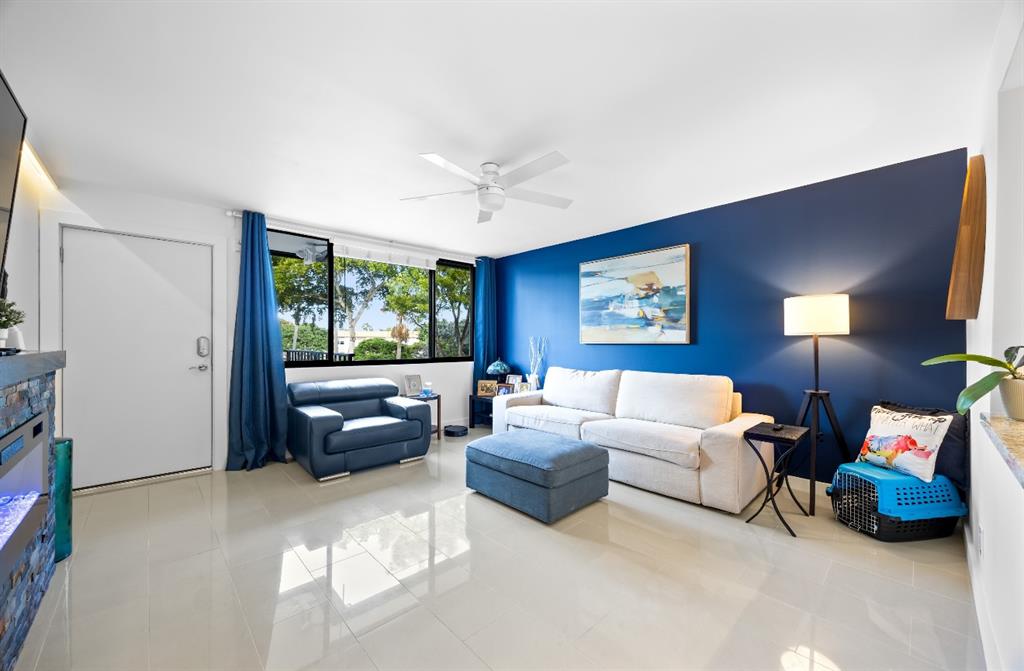 1901 North Andrews Avenue, Unit 222 Wilton Manors, FL 33311 - Photo 3 of 23 a living room with furniture and a large window