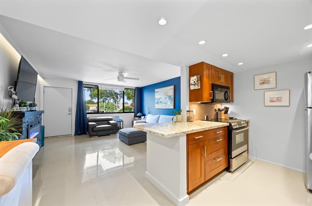 1901 North Andrews Avenue, Unit 222 Wilton Manors, FL 33311 - Photo 7 of 23 a view of a kitchen with kitchen island a large window in it
