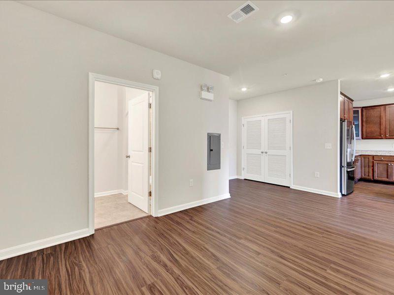 4003 Seaside Alder Road, Unit 308 ROSE Bowie, MD 20720 - Photo 5 of 44 a view of empty room with wooden floor