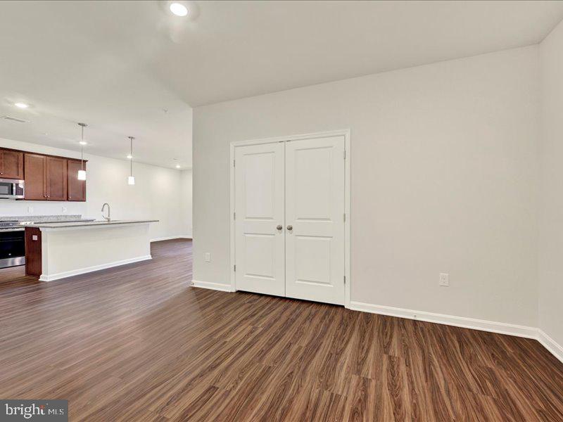4003 Seaside Alder Road, Unit 308 ROSE Bowie, MD 20720 - Photo 6 of 44 a view of a kitchen with wooden floor and a sink