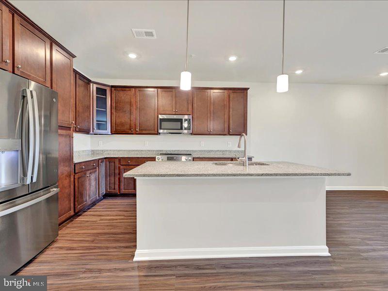4003 Seaside Alder Road, Unit 308 ROSE Bowie, MD 20720 - Photo 7 of 44 a kitchen with kitchen island a sink stainless steel appliances and cabinets
