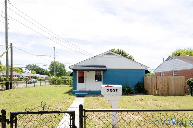 a view of a patio with table and chairs under an umbrella