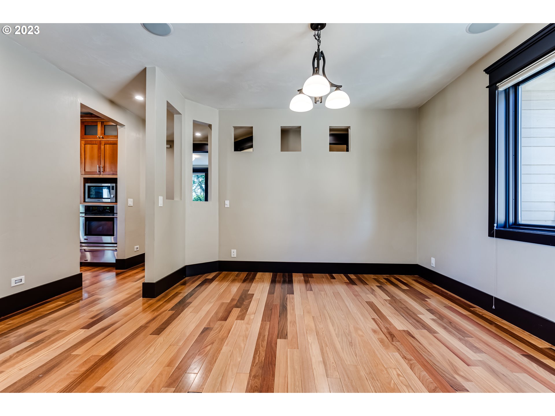 3321 Michael Lane Eugene, OR 97405 - Photo 12 of 46 a view of an empty room with wooden floor and a window