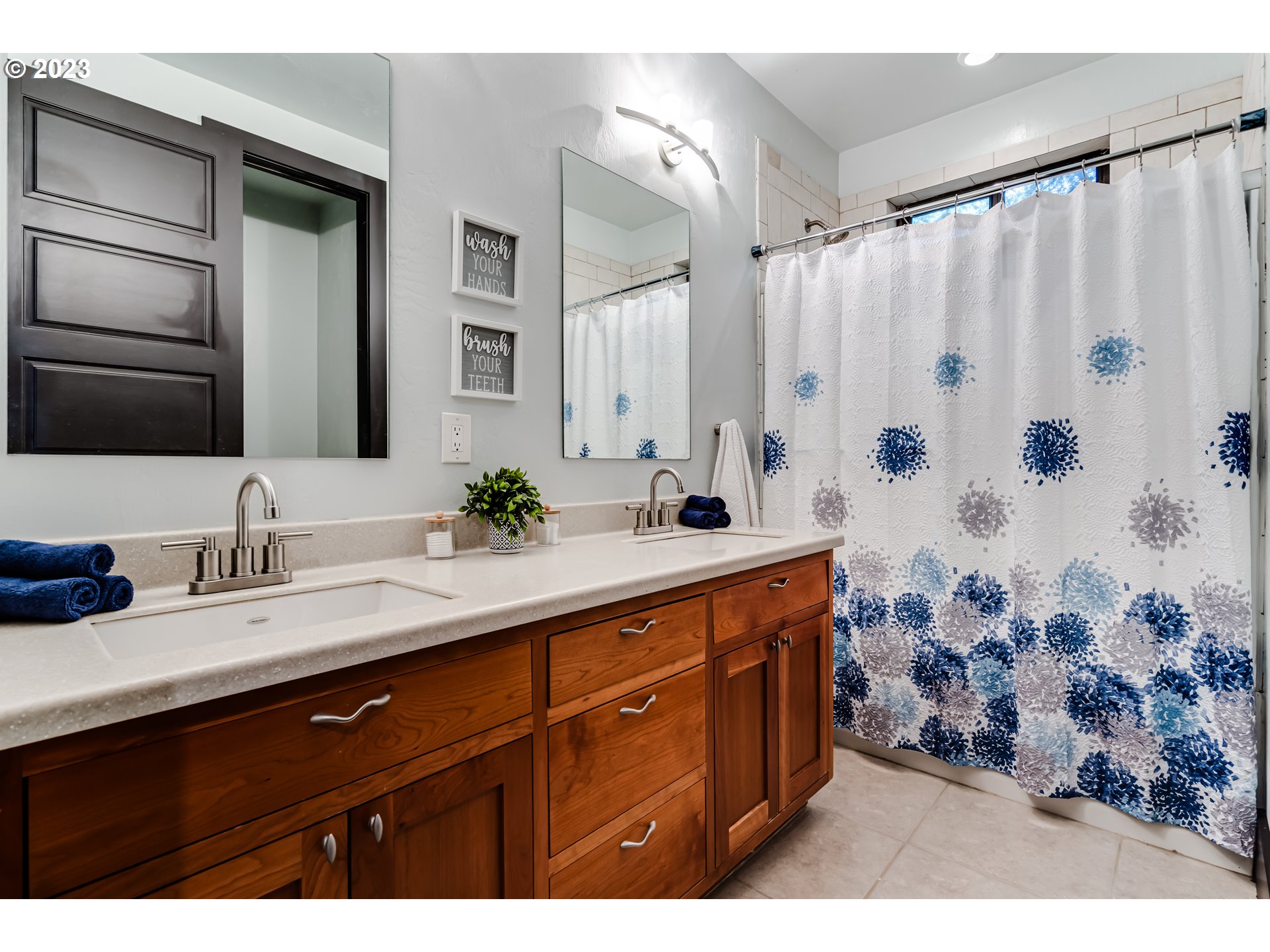 3321 Michael Lane Eugene, OR 97405 - Photo 31 of 46 a bathroom with a double vanity sink a mirror a and a shower