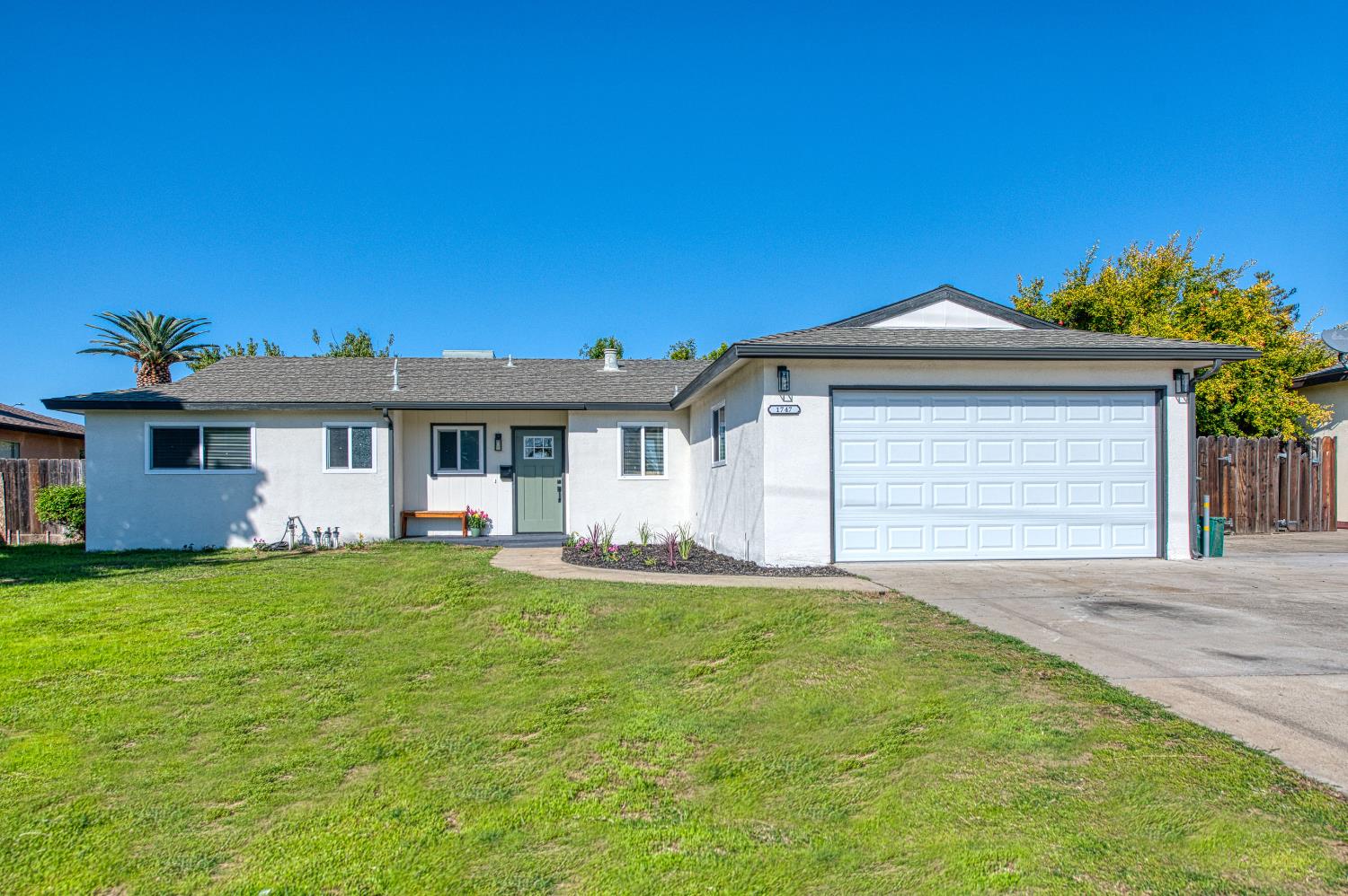 1747 Gettysburg Avenue Clovis, CA 93611 - Photo 1 of 39 a front view of a house with a garden and yard