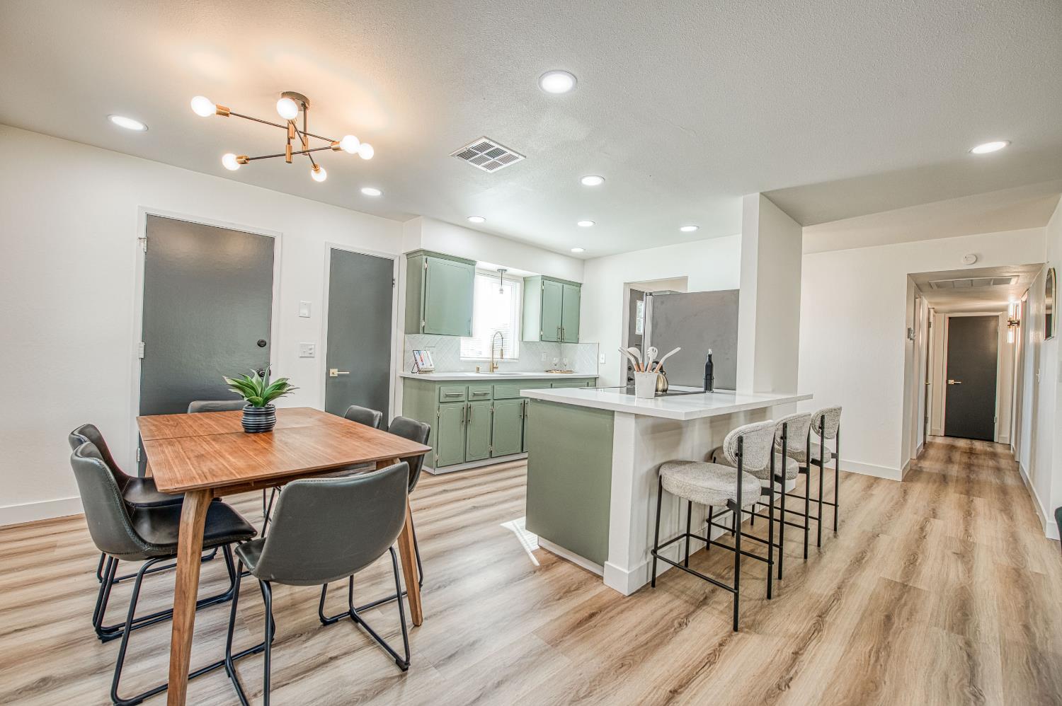 1747 Gettysburg Avenue Clovis, CA 93611 - Photo 13 of 39 a kitchen with stainless steel appliances kitchen island granite countertop a dining table chairs and granite counter tops