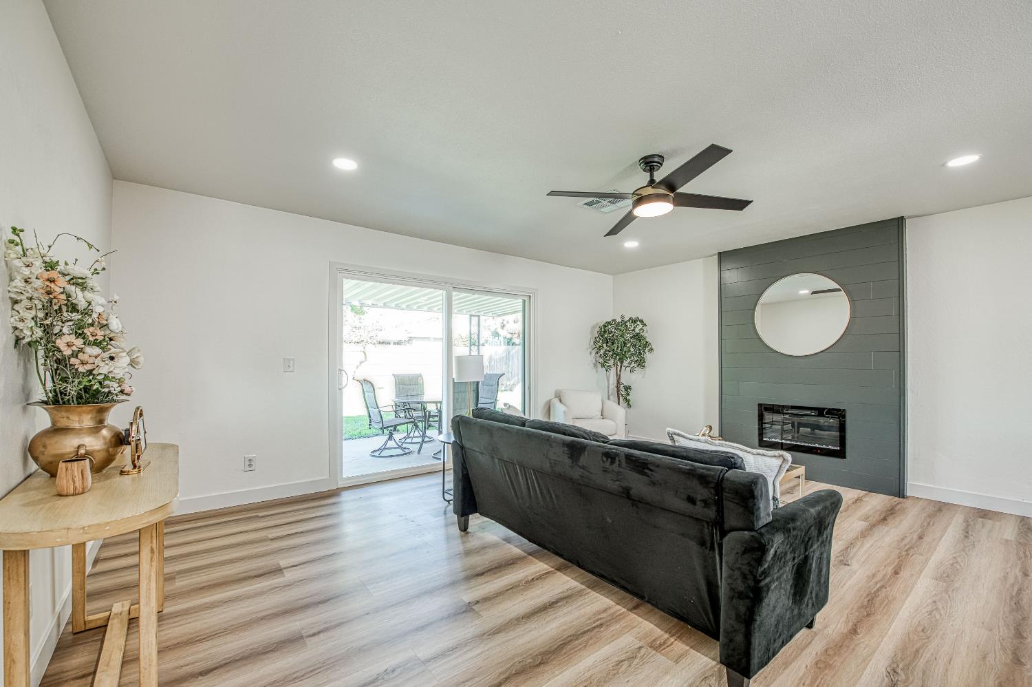1747 Gettysburg Avenue Clovis, CA 93611 - Photo 16 of 39 a living room with furniture chandelier and a fireplace