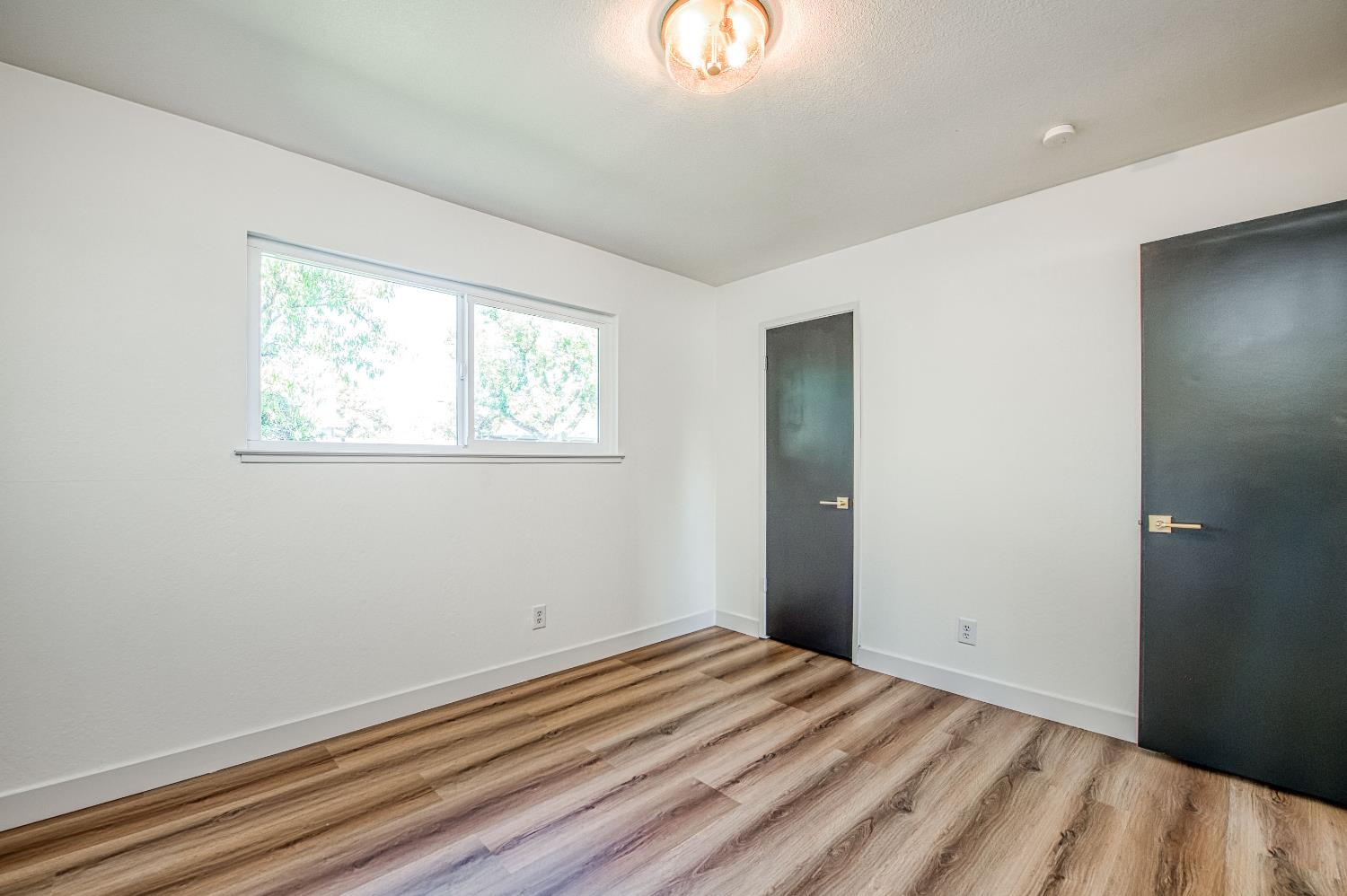 1747 Gettysburg Avenue Clovis, CA 93611 - Photo 24 of 39 a view of a room that has a bed and a dresser in it