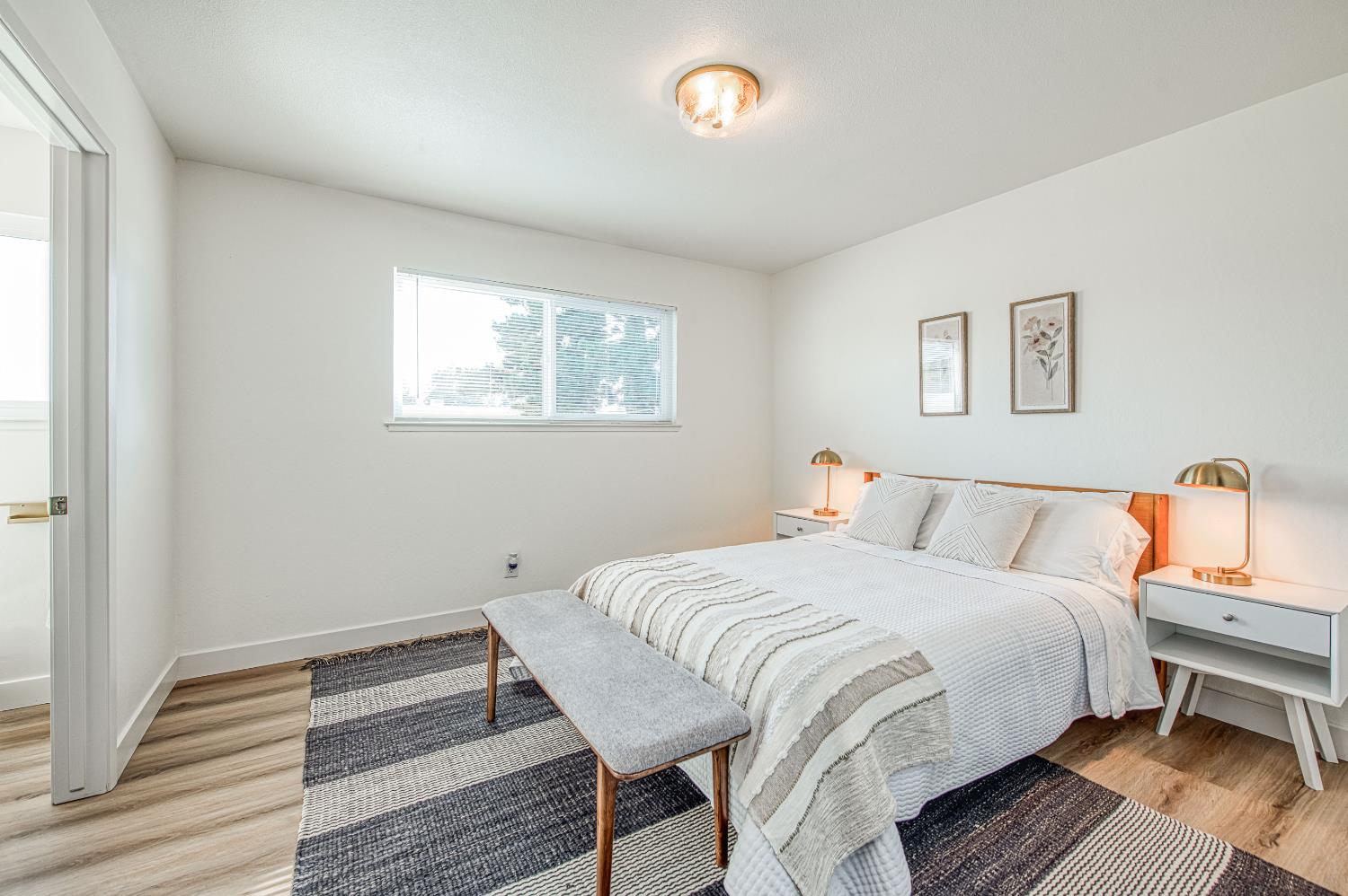 1747 Gettysburg Avenue Clovis, CA 93611 - Photo 25 of 39 a bedroom with a bed and wooden floor