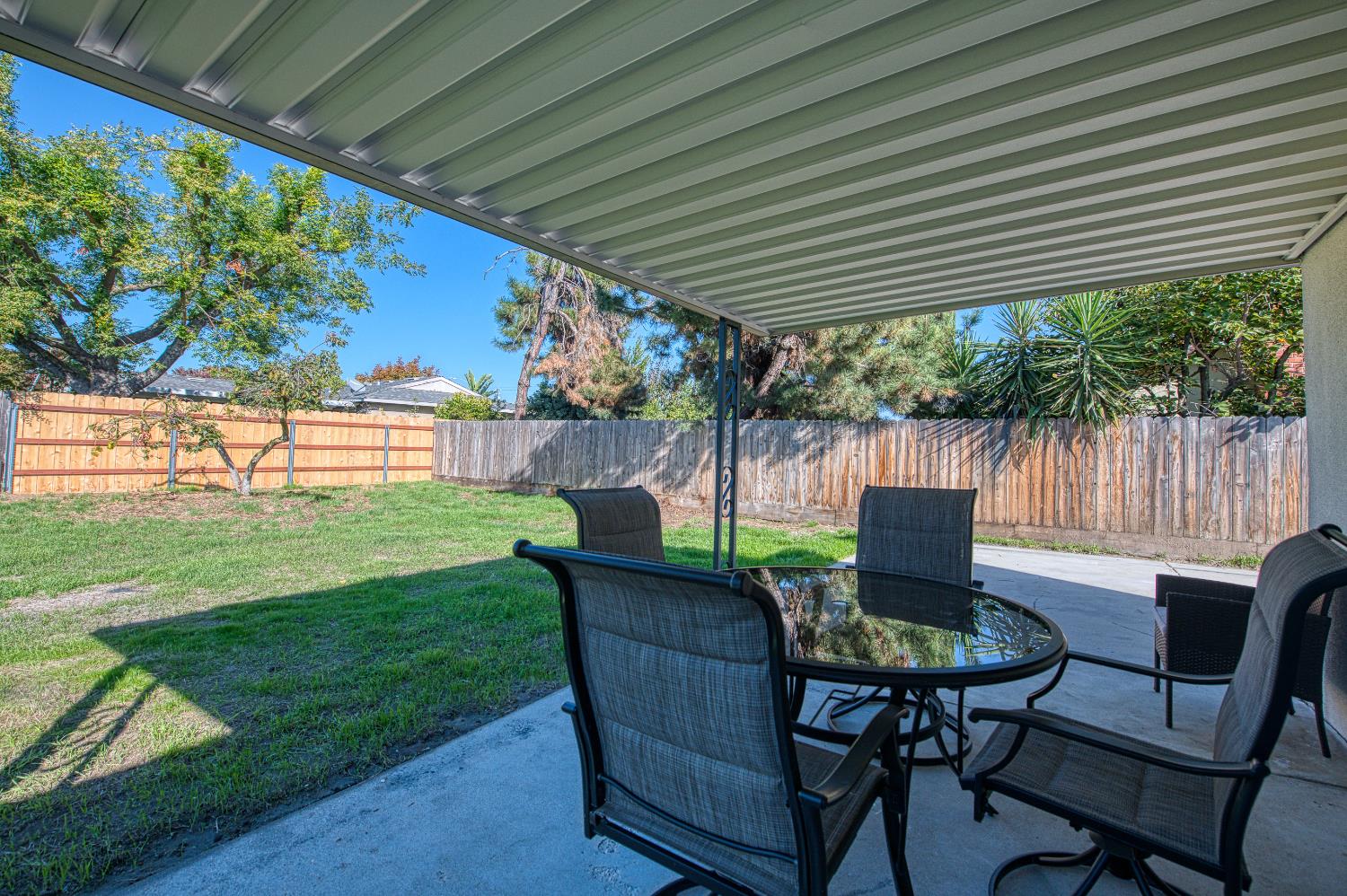 1747 Gettysburg Avenue Clovis, CA 93611 - Photo 28 of 39 a view of a chairs and table in patio with a yard