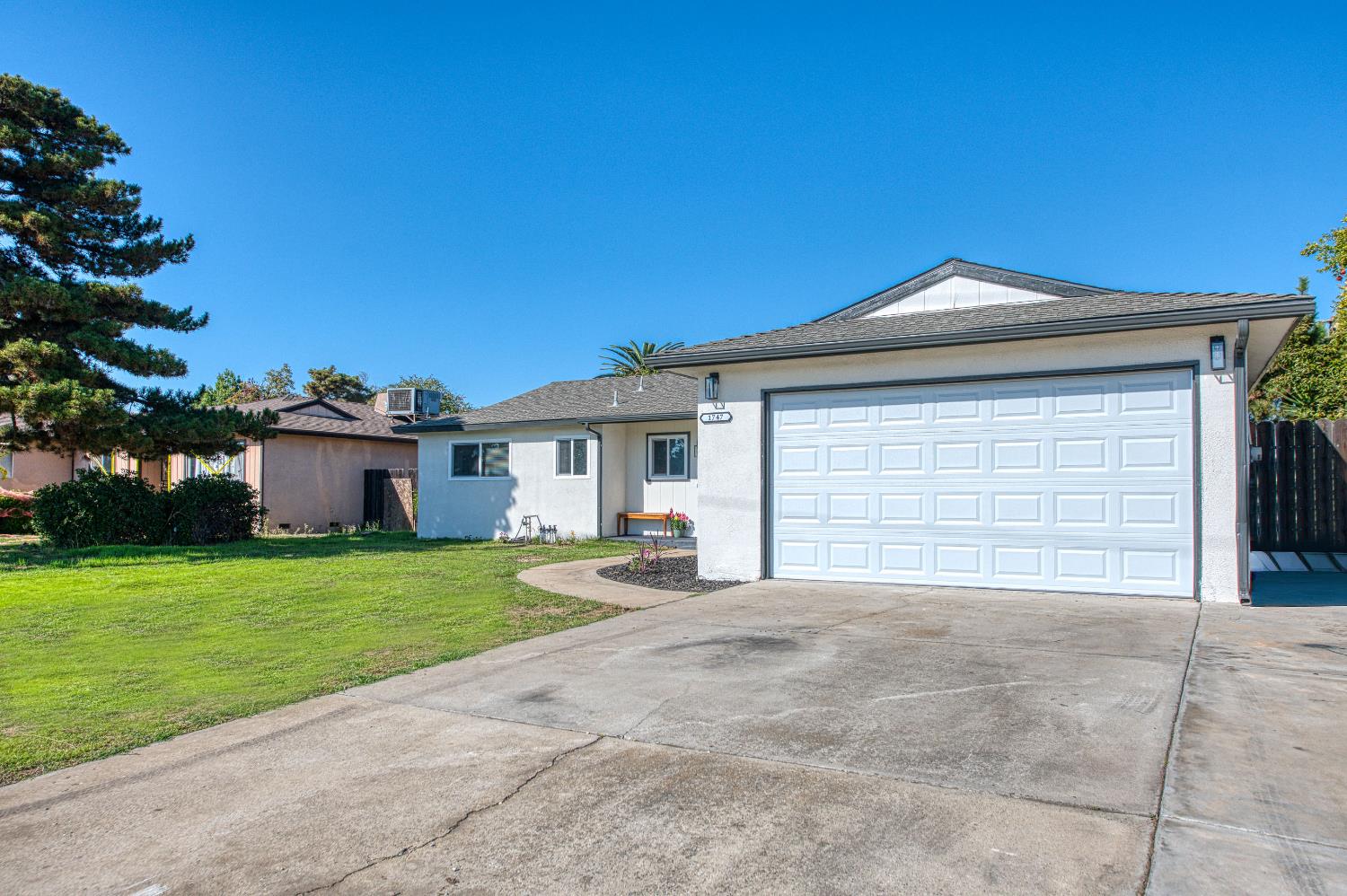 1747 Gettysburg Avenue Clovis, CA 93611 - Photo 37 of 39 a front view of a house with a yard and garage