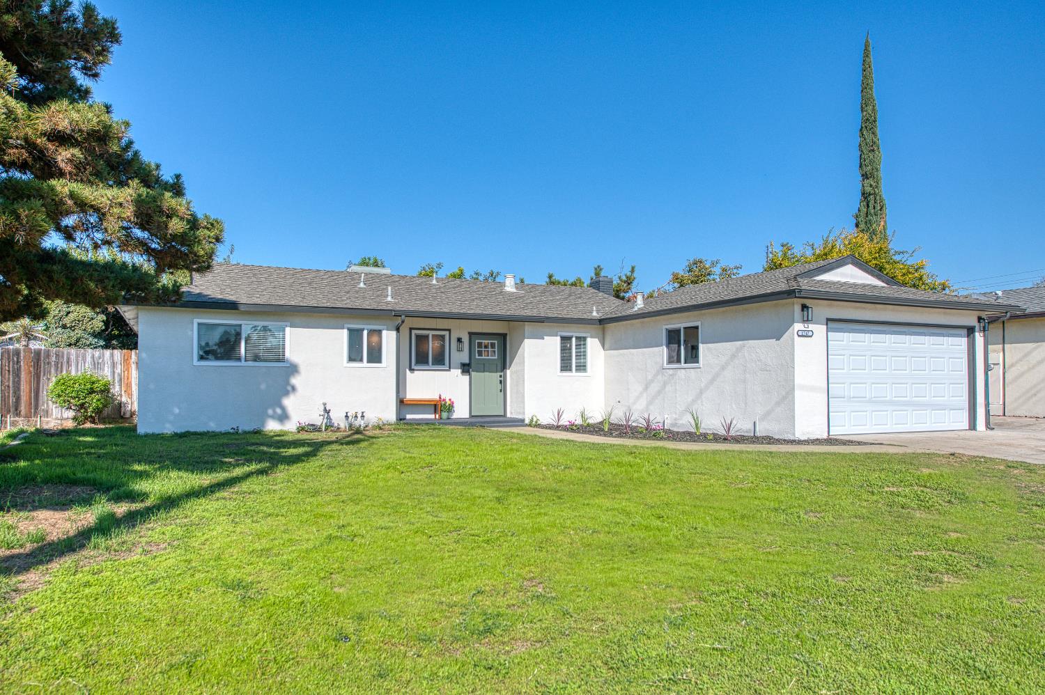 1747 Gettysburg Avenue Clovis, CA 93611 - Photo 38 of 39 a front view of a house with a garden and yard