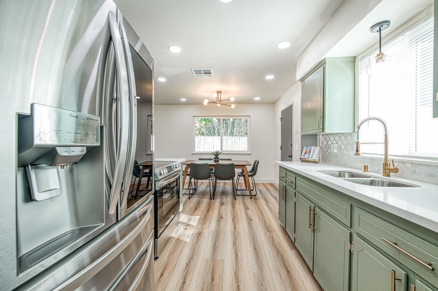 1747 Gettysburg Avenue Clovis, CA 93611 - Photo 7 of 39 a kitchen with counter top space a sink appliances and cabinets