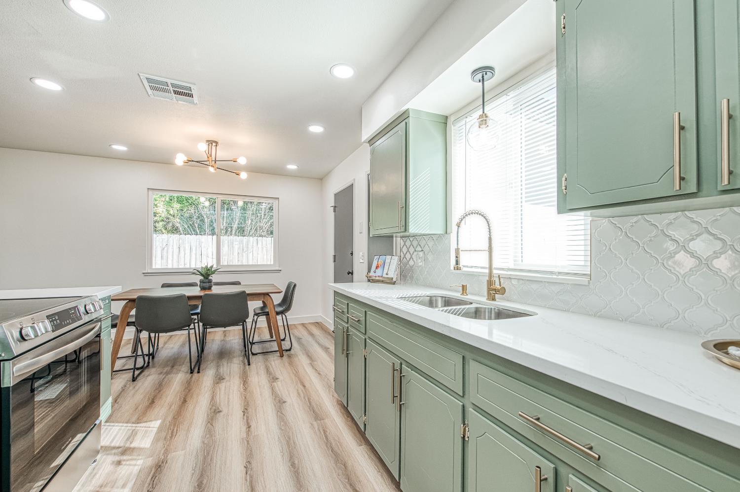 1747 Gettysburg Avenue Clovis, CA 93611 - Photo 8 of 39 a kitchen with a sink and wooden cabinets