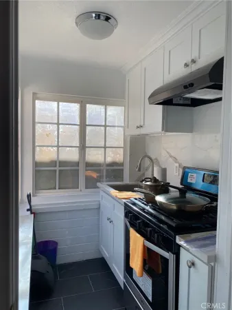 a kitchen with stainless steel appliances a stove and a microwave