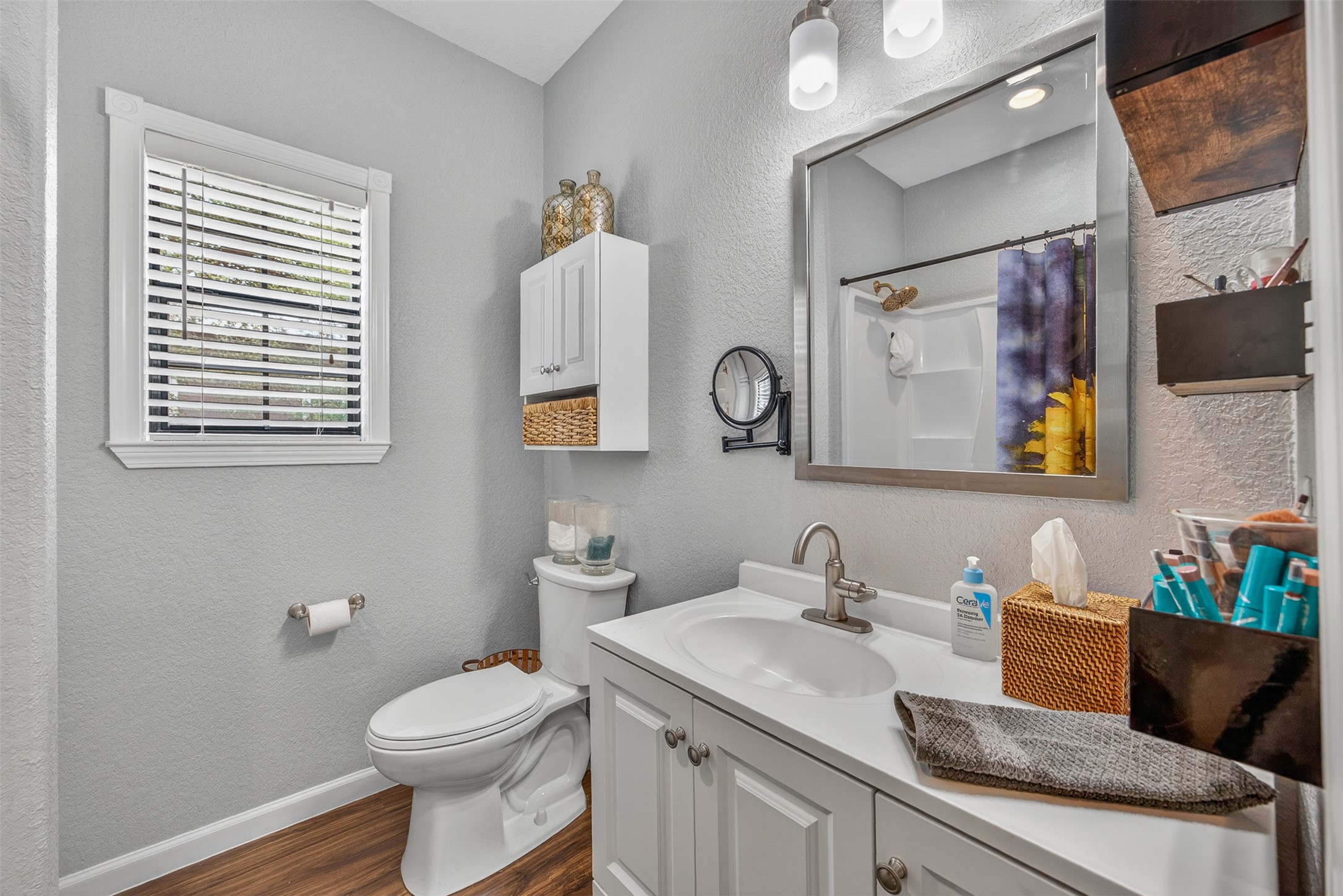 217 Walnut Avenue Luling, TX 78648 - Photo 17 of 38 a bathroom with a granite countertop sink mirror vanity and toilet