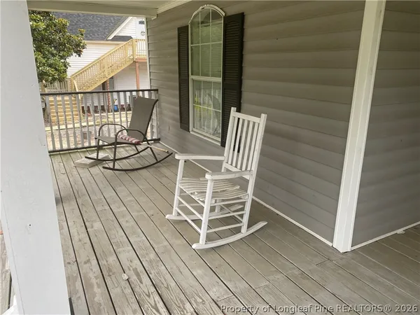 a view of a balcony with wooden floor