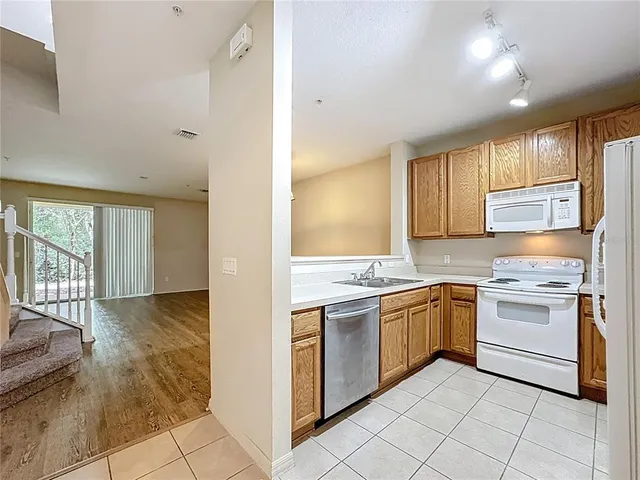 a kitchen with a stove a sink and a refrigerator