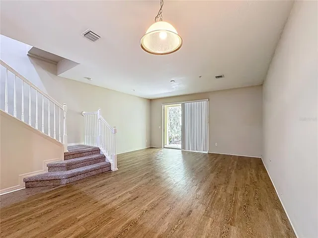 a view of an entryway with wooden floor