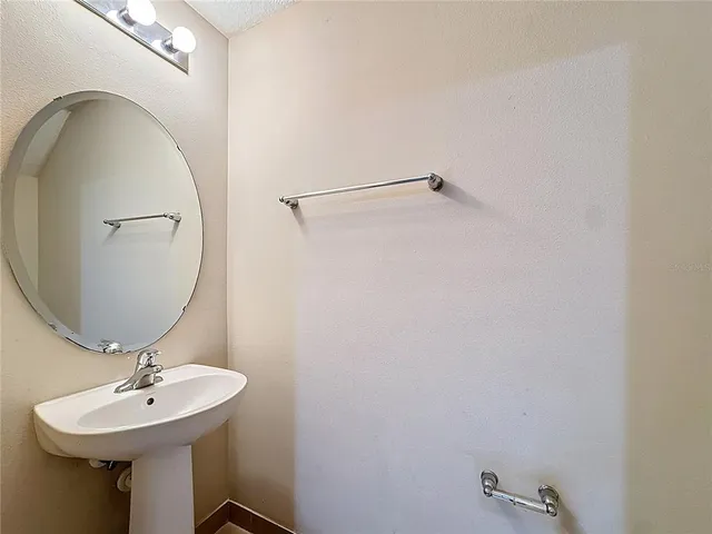 a bathroom with a sink a mirror and vanity