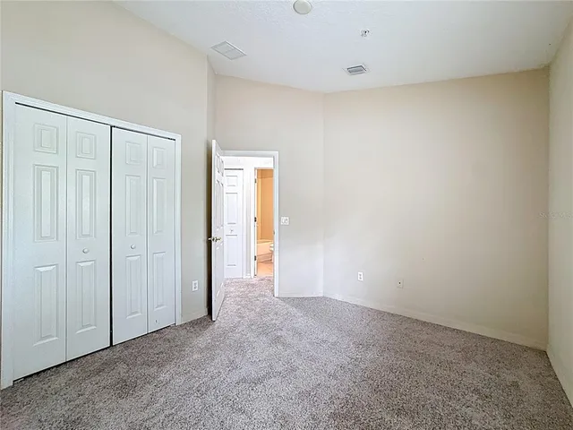 an empty room with closet area