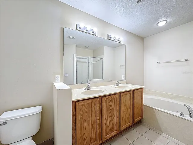 a spacious bathroom with a granite countertop sink mirror and toilet