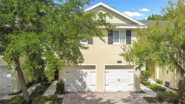 front view of a house with a tree