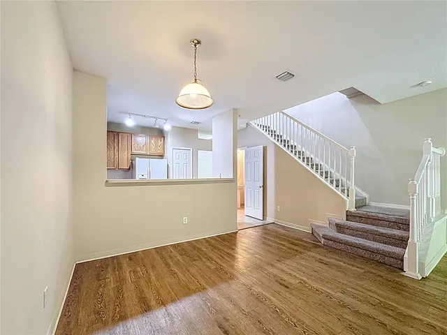 a view of entryway and hall with wooden floor