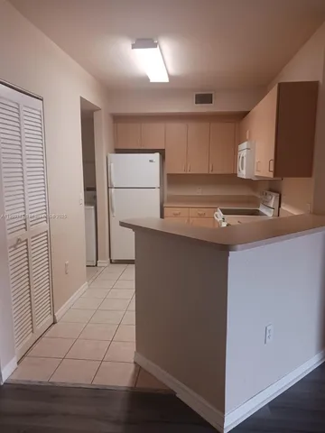 a kitchen with a sink and a refrigerator