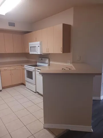 a kitchen with stainless steel appliances granite countertop a sink and a stove