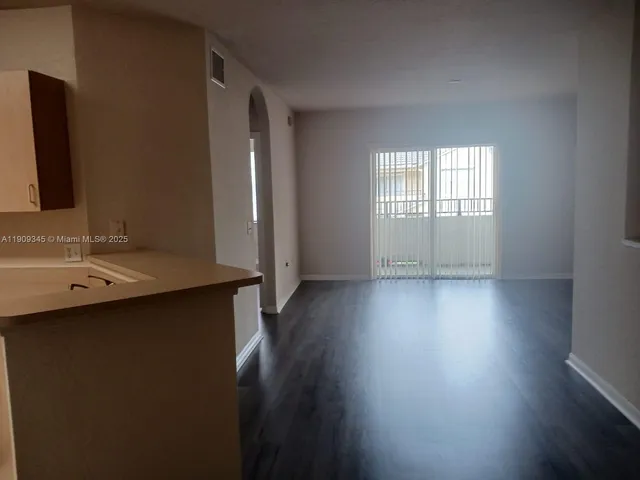 a view of a kitchen with a sink and a window