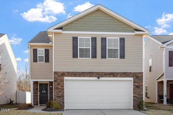 a front view of a house with a garage