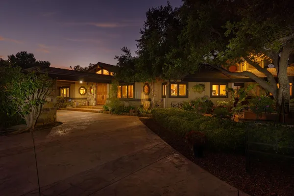 a view of swimming pool in front of residential houses with outdoor space