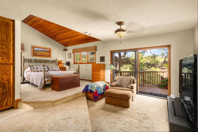 a bedroom with furniture and large windows