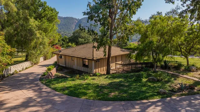 front view of a house with a tree in a yard