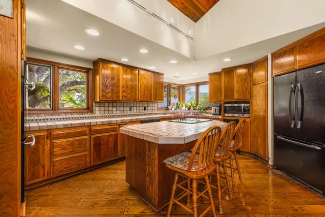 a kitchen with stainless steel appliances granite countertop a stove and a refrigerator