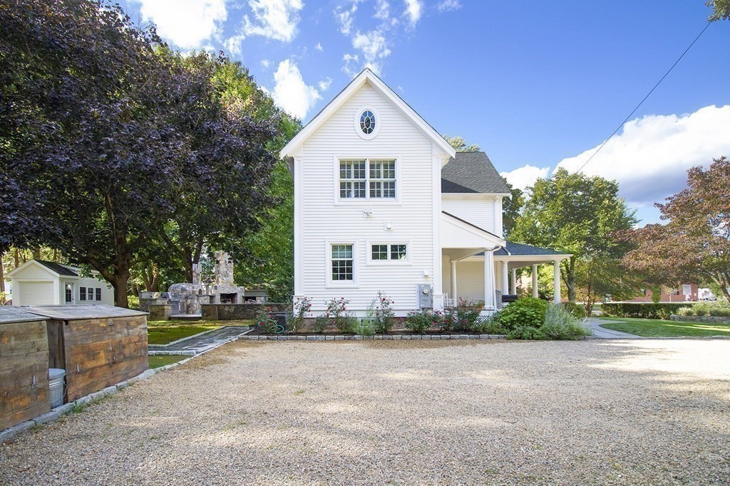 41-43 Stone Street Walpole, MA 02081 - Photo 27 of 36 a front view of a house with a yard and garage