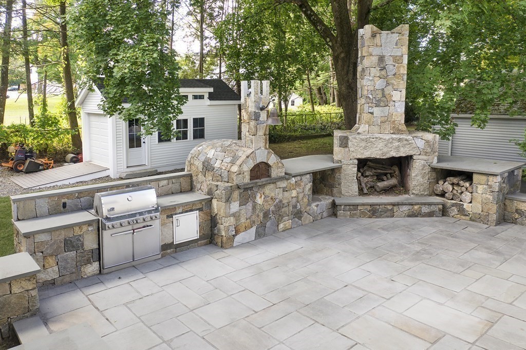 41-43 Stone Street Walpole, MA 02081 - Photo 29 of 36 a front view of a house with barbeque oven and outdoor seating