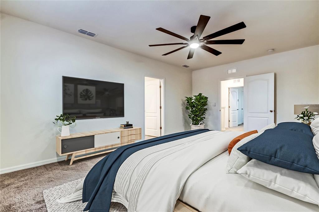 3845 Rory Pond Court Lakeland, FL 33811 - Photo 34 of 68 a bedroom with a large bed and a flat screen tv