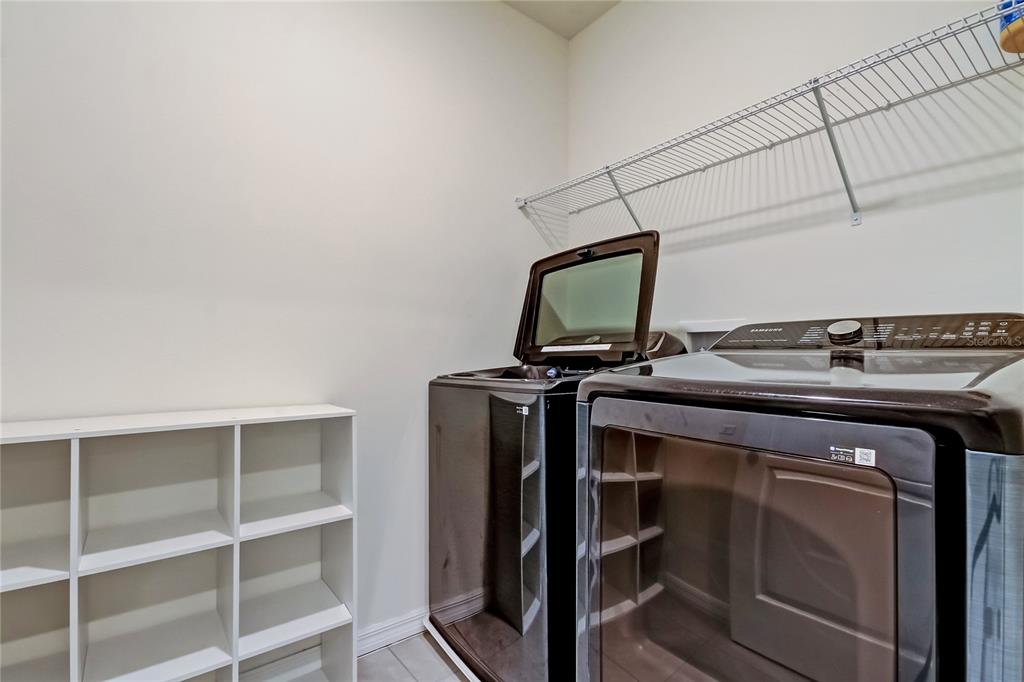 3845 Rory Pond Court Lakeland, FL 33811 - Photo 47 of 68 a view of storage and utility room with racks on the wall